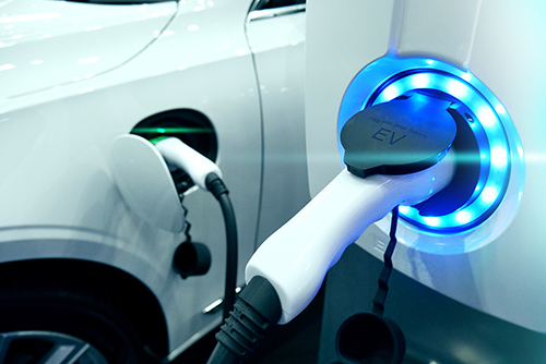 Power supply connect to electric vehicle for charge to the battery. Charging technology industry transport which are the futuristic of the Automobile. EV fuel Plug in hybrid car.